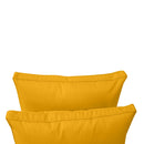 Pillow and bolster cushions displayed on an outdoor porch swing for a cozy, elegant setting.
