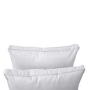 Pillow and bolster cushions displayed on an outdoor porch swing for a cozy, elegant setting.
