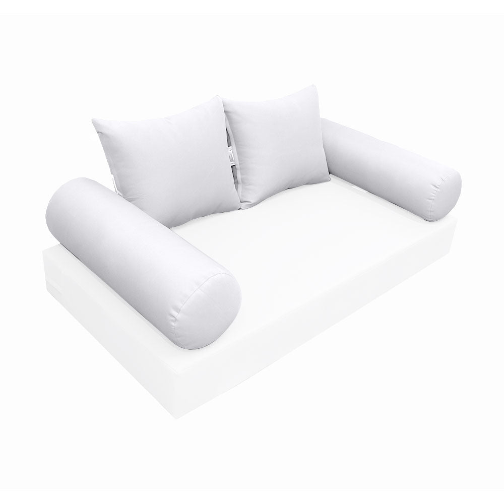 Elegant cushion and bolster set featuring refined craftsmanship and knife-edge detailing, designed for versatile indoor and outdoor comfort.