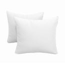 Pillow and bolster cushions displayed on an outdoor porch swing for a cozy, elegant setting.