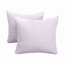 Pillow and bolster cushions displayed on an outdoor porch swing for a cozy, elegant setting.