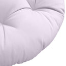 Close-up of papasan cushion fabric and tufted stitching detail.